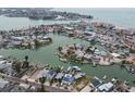 Aerial view of waterfront homes with canal access and boat docks, close to the beach at 301 Boca Ciega Dr, Madeira Beach, FL 33708