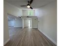 Spacious living room featuring sleek floors, a modern ceiling fan, and ample natural light at 3924 Orchard Hill Cir, Palm Harbor, FL 34684
