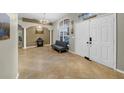 Welcoming home foyer with an elegant chandelier, tile floors, and a comfortable seating area at 4010 Lithia Ridge Blvd, Valrico, FL 33596