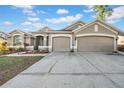 Inviting single-story home featuring a well-maintained lawn and a spacious three-car garage at 4010 Lithia Ridge Blvd, Valrico, FL 33596