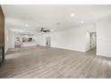 Open-concept space with new floors, fresh paint, modern lighting, connecting the living room and kitchen at 429 88Th Ave, St Pete Beach, FL 33706