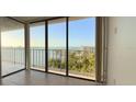 Bright living room featuring tile floors and large windows with beautiful water views and a balcony at 500 N Osceola Ave # 808, Clearwater, FL 33755