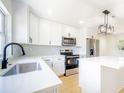 Kitchen with stainless steel appliances, bright white cabinets, quartz counters, and an island at 5290 101St Ave, Pinellas Park, FL 33782