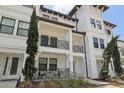 A bright, white townhome with large balconies and well-maintained landscaping at 5351 Bridge St # 15, Tampa, FL 33611