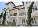 Elegant townhome with white exterior, dual balconies, and beautifully manicured greenery at 5351 Bridge St # 15, Tampa, FL 33611