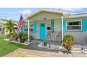 Cozy front porch with blue shutters, a 'WELCOME' sign, and a small seating area at 5638 13Th N Ave, St Petersburg, FL 33710