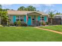 Quaint home featuring a well-manicured lawn, blue shutters, and a cozy front porch at 5638 13Th N Ave, St Petersburg, FL 33710