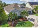 Aerial view of a well-maintained single-story home with a beautiful lawn and a two-car garage at 6326 Waves End Pl, Apollo Beach, FL 33572