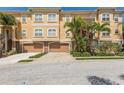 A beautiful condo building showing a two-car garage and nicely landscaped yard at 6533 Channelside Dr, New Port Richey, FL 34652