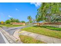 Community entrance featuring lush landscaping, mature trees, and brick signage under a clear blue sky at 6920 Lafayette N # 6920, Pinellas Park, FL 33781