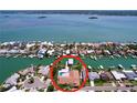 Aerial view of waterfront home featuring a private pool and dock at 773 Snug Is, Clearwater Beach, FL 33767