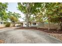 Inviting home with mature trees and nice landscaping, including a mulched area and defined brick border at 8031 7Th N St, St Petersburg, FL 33702