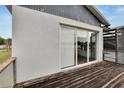Exterior view of sliding glass doors on a deck overlooking a lake at 828 Bayshore Dr, Tarpon Springs, FL 34689