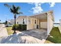 Well-maintained single-story home with covered parking and a glimpse of a serene lake nearby at 8528 Fantasia Park Way, Riverview, FL 33578
