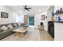 Comfortable living room featuring a sectional sofa, neutral rug, and sliding glass doors to the outdoor area at 9481 Highland Oak Dr # 514, Tampa, FL 33647
