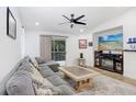 Living room with sectional sofa, neutral rug, flatscreen TV, and a sliding glass door to the outdoor area at 9481 Highland Oak Dr # 514, Tampa, FL 33647