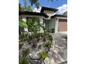 Attractive front yard with lush landscaping, decorative stones, and a charming facade at 2917 W Fern St, Tampa, FL 33612