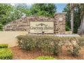 Community sign with stone base and manicured landscaping at 10103 Courtney Oaks Cir # 103, Tampa, FL 33619