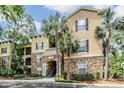Attractive condo building with stone accents, palm trees, and a well-maintained landscape at 10103 Courtney Oaks Cir # 103, Tampa, FL 33619