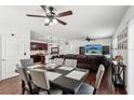 Open-concept with dining area, large leather sectional and hardwood floors at 10230 Geese Trail Cir, Sun City Center, FL 33573