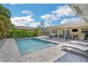 Inviting backyard pool and deck area featuring lounge seating and dining space at 1137 86Th N Ave, St Petersburg, FL 33702