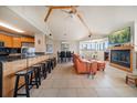 Open-concept living area with vaulted ceilings, tile floors, and a cozy fireplace at 118 94Th Ave, Treasure Island, FL 33706