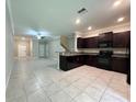 Open kitchen featuring dark cabinets and stainless steel appliances at 11823 Dumaine Valley Rd, Riverview, FL 33579