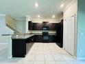 Bright kitchen featuring granite countertops and dark wood cabinets at 11823 Dumaine Valley Rd, Riverview, FL 33579