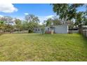 Expansive backyard featuring a large lawn and patio attached to a single story home at 12430 Oconee Blvd, New Port Richey, FL 34654