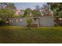 Inviting single-story home with a covered front porch and lush green lawn at 12430 Oconee Blvd, New Port Richey, FL 34654