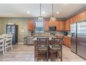 Spacious kitchen featuring stainless appliances, granite countertops, and a central island with seating at 1418 Rushgrove Cir, Dover, FL 33527