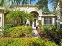 Inviting entrance with manicured landscaping, arched entryway, and decorative front door at 15254 Bellamy Rd, Tampa, FL 33625