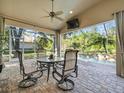Relaxing screened-in patio with ceiling fan, outdoor seating, and views of the private pool at 15254 Bellamy Rd, Tampa, FL 33625