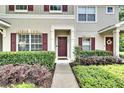 Inviting townhome entrance with well-maintained landscaping and a charming front door at 15825 Fishhawk View Dr, Lithia, FL 33547