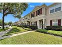 Attractive townhome community featuring manicured lawns, sidewalks, and inviting exteriors at 15825 Fishhawk View Dr, Lithia, FL 33547