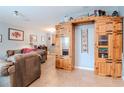 Spacious living room featuring tile floors and wood furniture at 15939 Fishhawk View Dr, Lithia, FL 33547