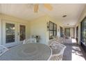 Covered outdoor patio with tile flooring and comfortable seating arrangement, great for entertaining at 1616 Laughton Pl, Sun City Center, FL 33573