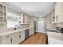 Bright kitchen features updated cabinets, countertops, modern appliances, and stylish hardwood floors at 208 Ne Lincoln N Cir, St Petersburg, FL 33702