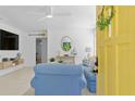 Bright living room with a yellow door, comfortable seating, and charming nautical decor at 2215 Thrace St, Tampa, FL 33605