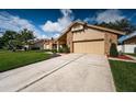Inviting single-Gathering home with brick facade, manicured lawn, and a spacious two-car garage at 2392 Hillcreek E Cir, Clearwater, FL 33759