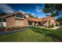 Beautiful single-Gathering home featuring manicured landscaping and a combination of brick and siding exterior at 2392 Hillcreek E Cir, Clearwater, FL 33759