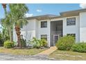 Well-maintained two-story condo with stucco exterior and landscaped grounds with mature palms at 2427 Twin Dr # 2, Sarasota, FL 34234