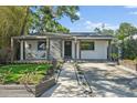 Charming home featuring a modern design with a covered porch and well-manicured front yard at 3027 Burlington N Ave, St Petersburg, FL 33713