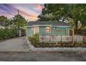 Cozy home with a charming, fenced-in front porch, complimented by lovely landscaping and outdoor lighting at 3027 Burlington N Ave, St Petersburg, FL 33713