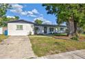 View of house with green grass and small trees at 321 Shore E Dr, Oldsmar, FL 34677