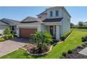 Beautiful two-story home with a brick paved driveway and a well-manicured lawn at 34135 White Fountain Ct, Wesley Chapel, FL 33545