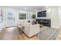 Cozy living room featuring a modern fireplace, mounted TV, and comfortable seating at 401 N Manhattan Ave, Tampa, FL 33609