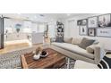 Bright living room with a neutral sofa, wooden coffee table, and stylish decor at 401 N Manhattan Ave, Tampa, FL 33609