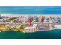 Overhead view displays a yellow condo with docks on the water, set against a beachfront backdrop at 4103 Gulf Blvd # 106, St Pete Beach, FL 33706