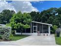 Charming single-story home features a spacious screened-in porch and well-manicured front yard with lush landscaping at 4485 49Th N Ave, St Petersburg, FL 33714